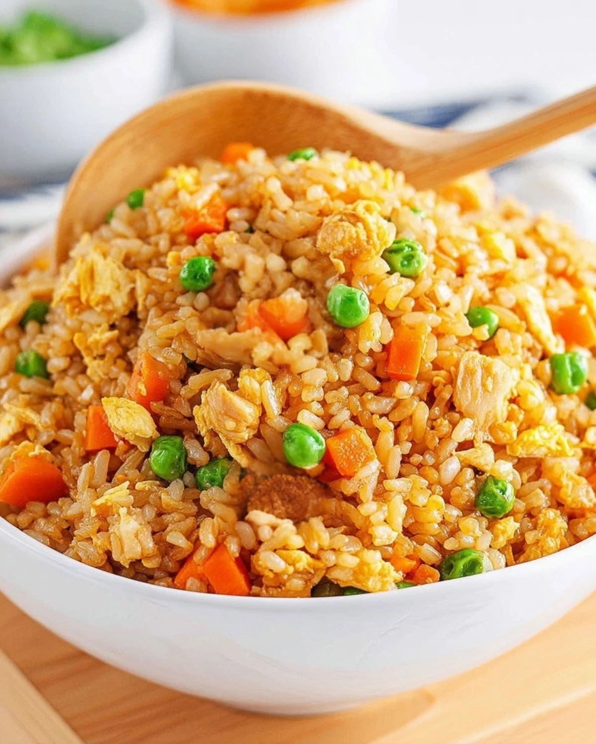 A bowl of homemade fried rice with vegetables and eggs, garnished with green onions.