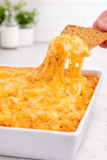 Creamy Buffalo Chicken Dip served in a bowl, garnished with green onions.