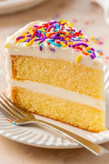 Homemade easy vanilla cake decorated with frosting and sprinkles