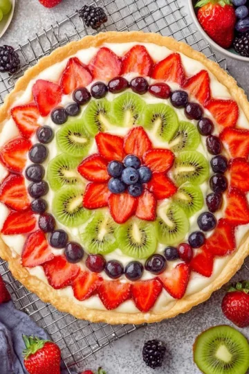 Delicious fruit pizza topped with cream cheese frosting and a variety of fresh fruits