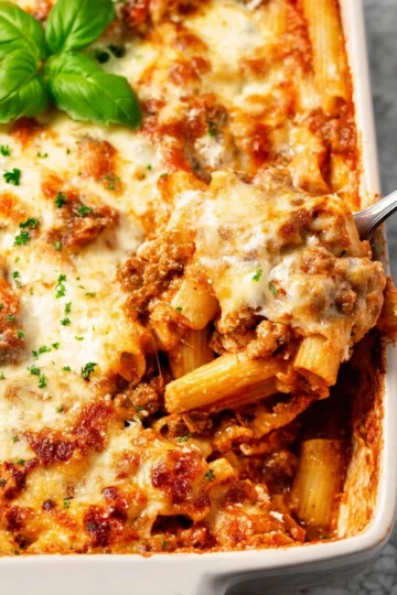 Delicious baked ziti topped with melted cheese and herbs