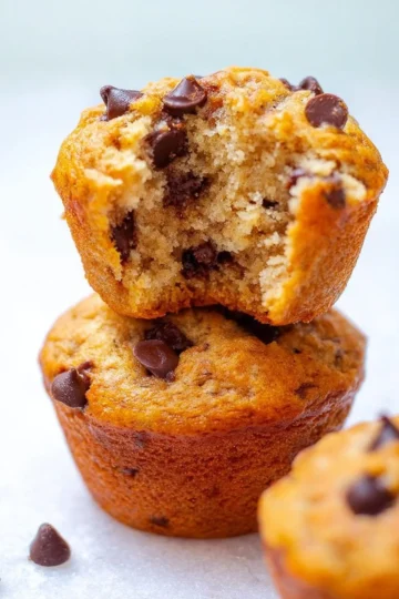 Freshly baked banana chocolate chip muffins on a cooling rack
