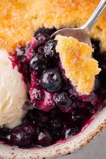 Freshly baked blueberry cobbler served in a dish