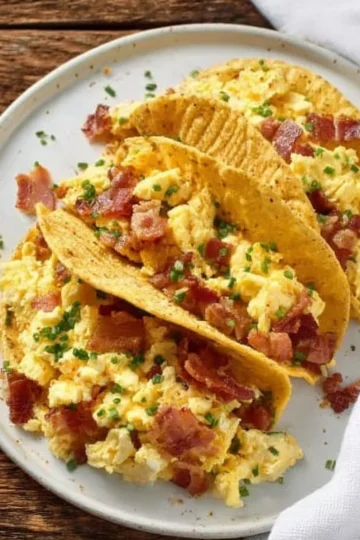 A delicious plate of breakfast tacos topped with fresh ingredients.