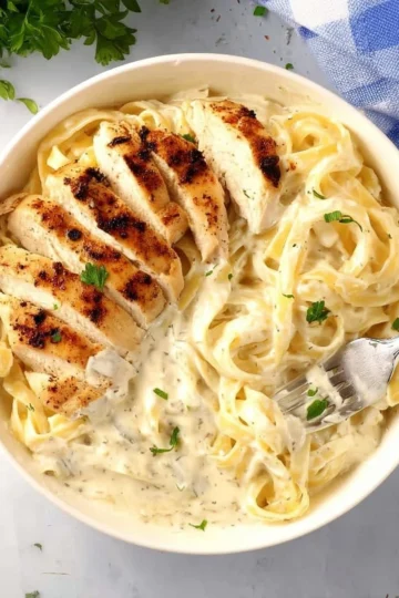 Creamy Chicken Alfredo pasta with grilled chicken and a rich Alfredo sauce