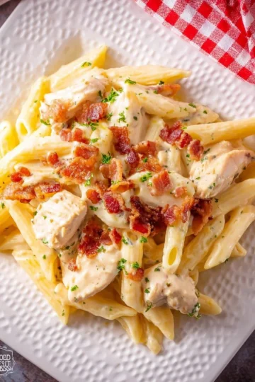 Creamy Chicken Bacon Ranch Pasta topped with crispy bacon and herbs