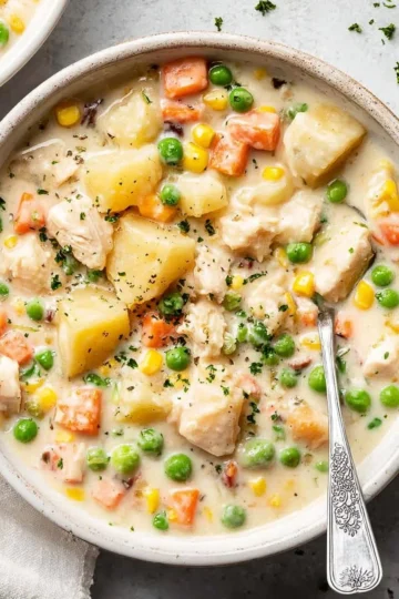 Crockpot Chicken Pot Pie Soup served in a bowl with fresh herbs garnish