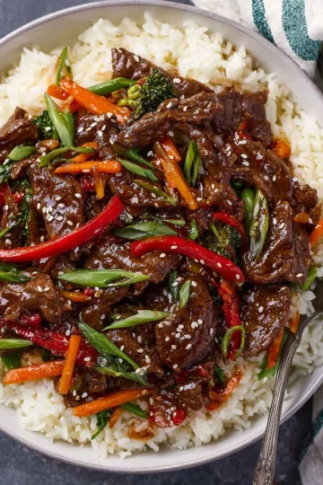 Delicious easy Mongolian beef served with vegetables and rice