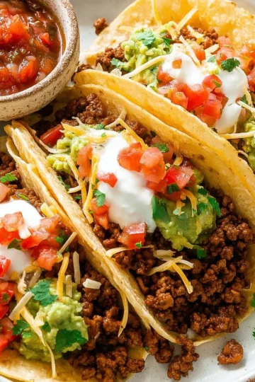 Homemade ground beef tacos served with fresh toppings.