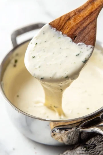 Homemade Alfredo Sauce prepared with fresh ingredients and herbs.