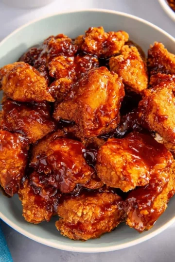 Delicious plate of crispy Korean Fried Chicken served with dipping sauce