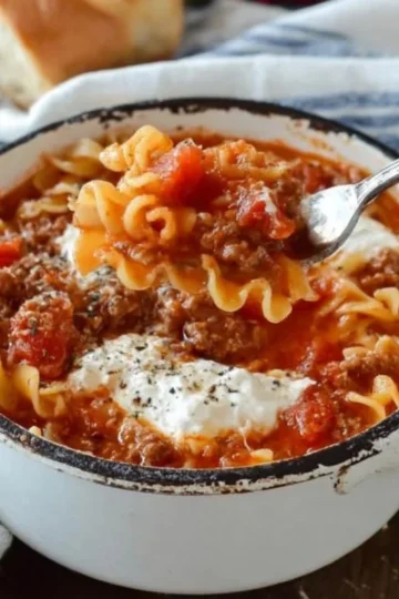 A delicious bowl of lasagna soup garnished with herbs and cheese