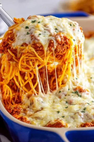 Delicious Million Dollar Spaghetti served in a bowl with fresh herbs