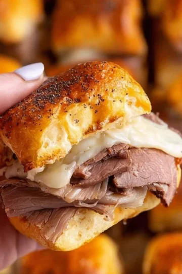 Platter of savory roast beef sliders with fresh ingredients and toppings