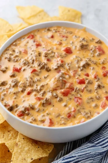 Rotel dip with ground beef served in a bowl with tortilla chips