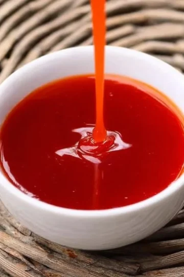 Homemade sweet and sour sauce drizzled over chicken and vegetables