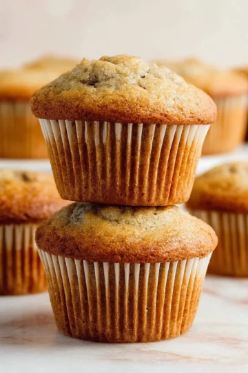 Delicious homemade banana bread muffins topped with walnuts and chocolate chips