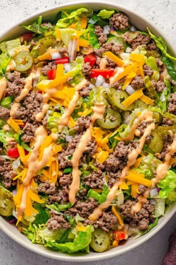 Delicious Big Mac Salad topped with lettuce, cheese, and special sauce