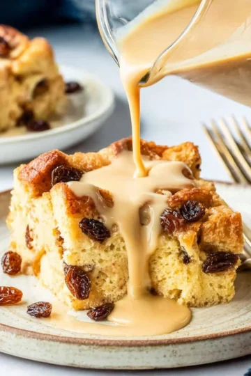 Delicious bread pudding drizzled with vanilla caramel sauce on a plate.