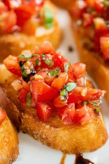 Delicious bruschetta topped with fresh tomatoes and basil on toasted bread