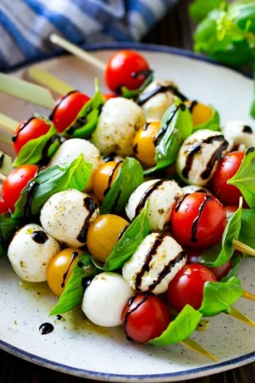 Delicious Caprese Skewers with tomatoes, mozzarella, and basil on a plate.