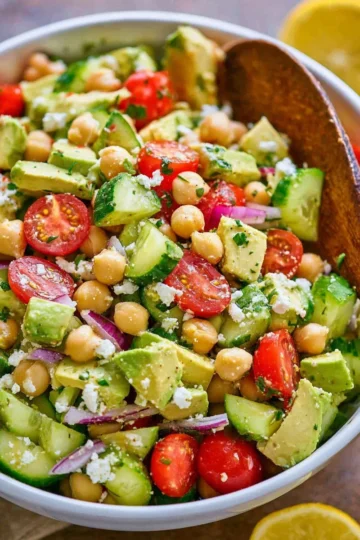 Colorful chickpea salad with fresh vegetables and dressing
