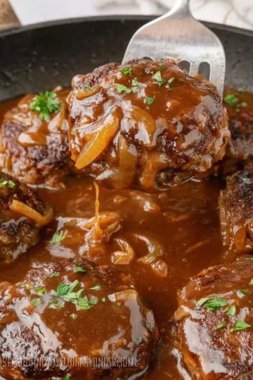 Classic Salisbury Steak served with rich gravy and mashed potatoes.