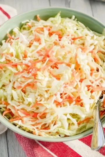 Bowl of fresh coleslaw with colorful shredded cabbage and dressing