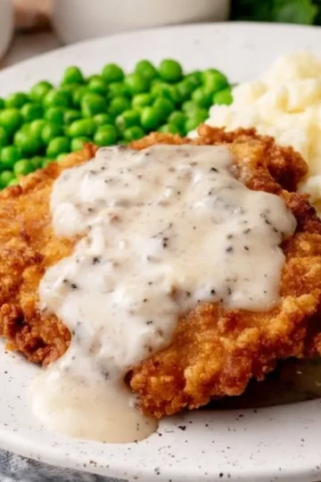 Delicious Country Fried Steak served with creamy gravy on a plate