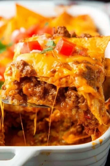 Delicious Doritos Casserole topped with cheese and crunchy Doritos