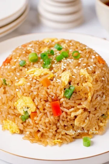 Bowl of easy homemade egg fried rice with vegetables and soy sauce
