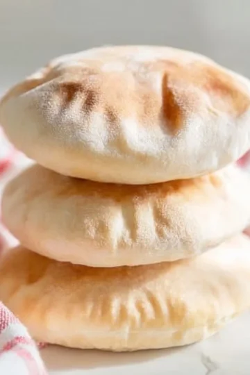 Homemade pita bread fresh out of the oven, perfect for various dishes.