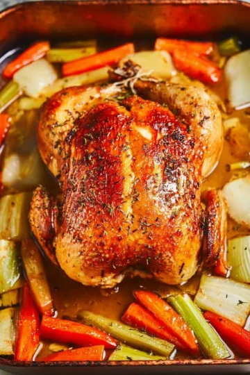Easy whole roasted chicken seasoned and cooked to perfection on a platter
