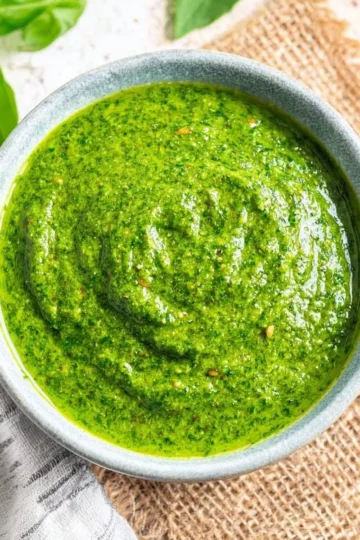 Bowl of fresh basil pesto with pine nuts and olive oil