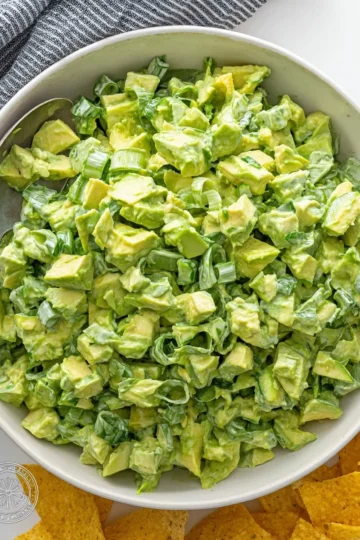 A bowl of fresh Green Goddess Salad with colorful vegetables and creamy dressing.