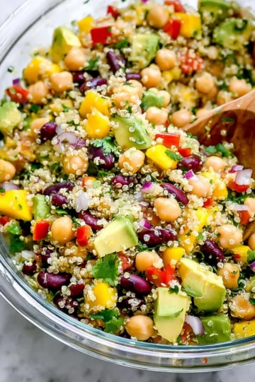 Colorful healthy quinoa salad with fresh vegetables and herbs.