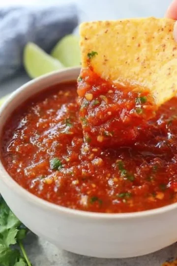 Fresh homemade salsa in a bowl with vibrant tomatoes, onions, and cilantro