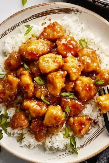 Honey Garlic Chicken dish garnished with green onions on a plate.