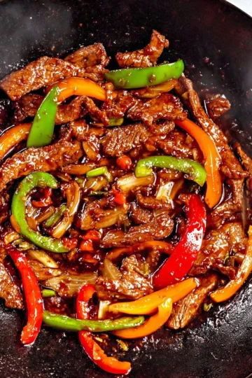 Pepper steak stir fry with colorful vegetables and tender beef in a bowl