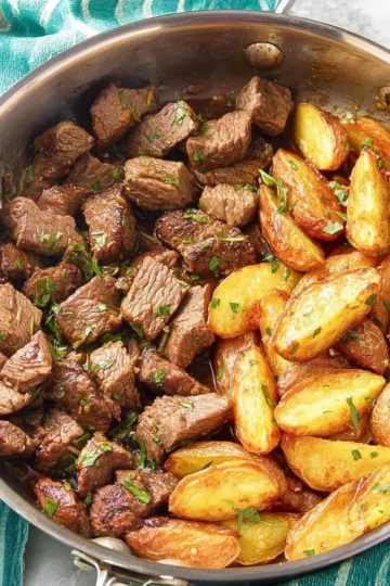 Plate of delicious steak bites and crispy potatoes