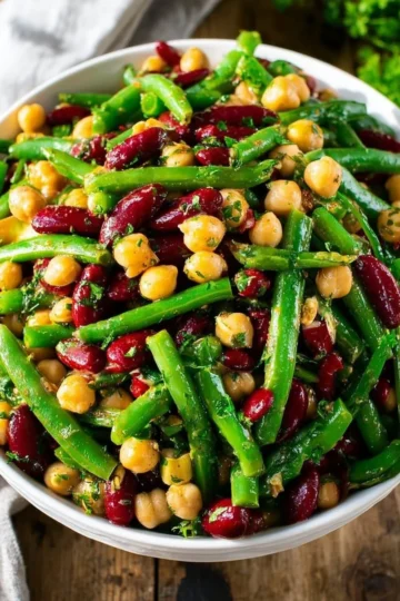 Colorful Three Bean Salad with fresh vegetables and dressing