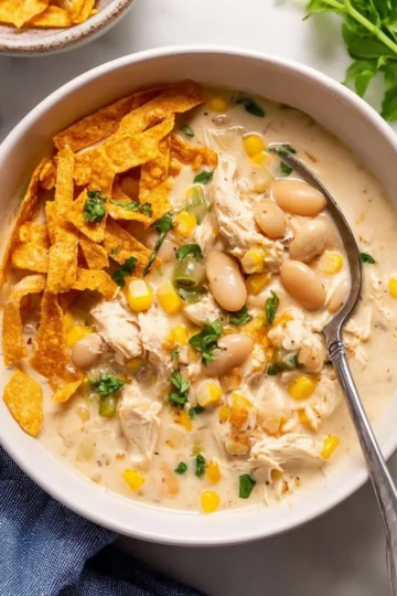 Delicious bowl of creamy white chicken chili topped with herbs.