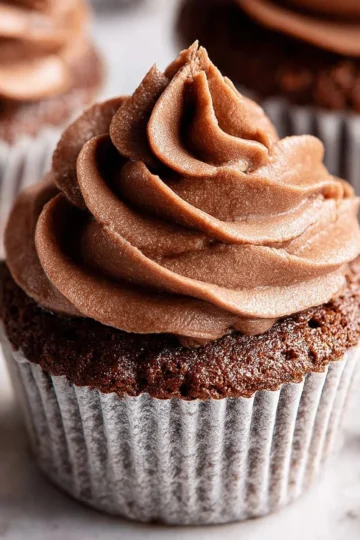 Delicious chocolate buttercream frosting spread on a chocolate cake