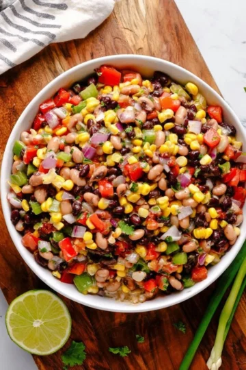 A colorful bowl of Cowboy Caviar featuring black-eyed peas and fresh vegetables.