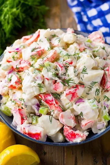 Delicious bowl of fresh crab salad with vegetables and dressing
