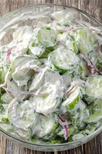 Image of creamy cucumber salad with fresh ingredients and dressing