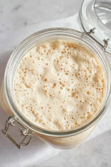 Homemade easy sourdough starter in a jar with flour and water