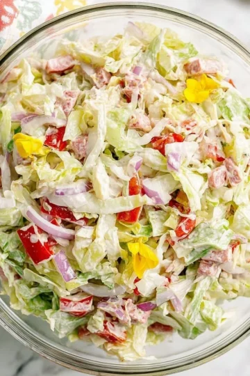 A refreshing bowl of Grinder Salad featuring mixed greens and vibrant vegetables.