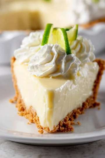 Delicious homemade Key Lime Pie with a graham cracker crust and lime garnish