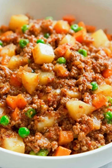 Delicious homemade Mexican Picadillo served with rice and garnished with cilantro.